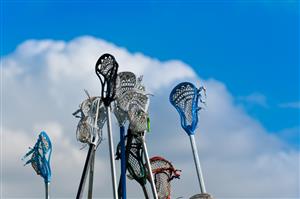 Lacrosse sticks held up in the air